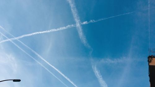 Low angle view of vapor trails in sky