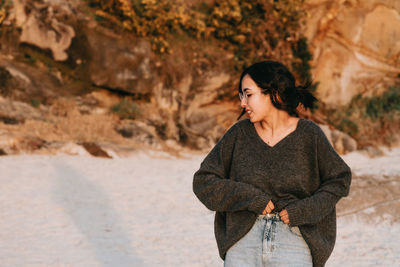 Young woman standing on rock