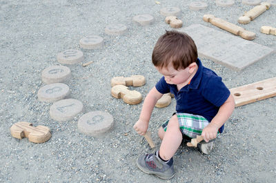 Little boy playing in the dirt at a outdoor kids museum