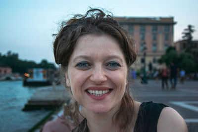 Portrait of smiling woman in city