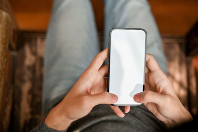 Midsection of woman using mobile phone