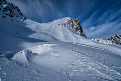 Low angle view of snowcapped mountains against sky