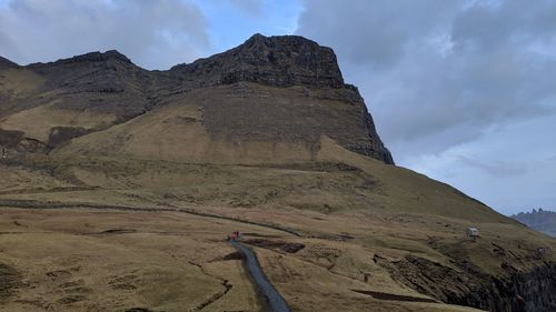 Low angle view of mountain against cloudy sky