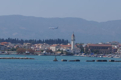 View of sea and city against sky