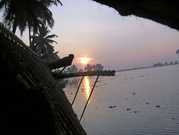 Close-up of sea against sky at sunset
