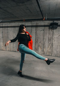 Young woman dancing in garage