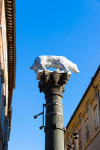 Low angle view of building against clear blue sky