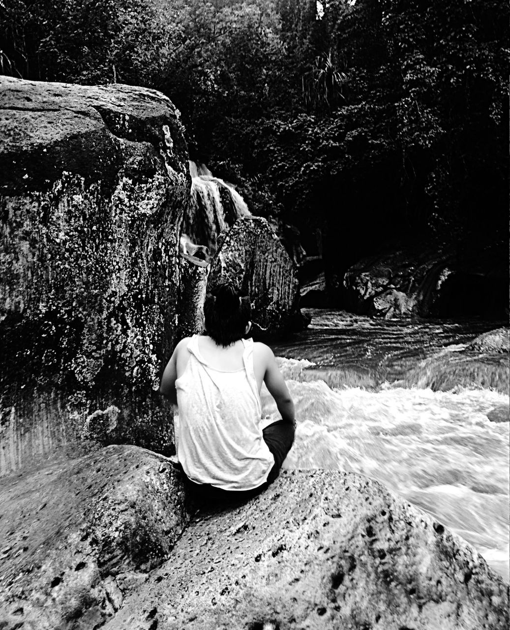 rear view, lifestyles, leisure activity, full length, casual clothing, men, person, sitting, relaxation, rock - object, childhood, tree, nature, standing, day, outdoors, walking