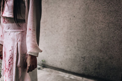 Midsection of woman with blood on hands