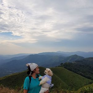 People on mountain against sky