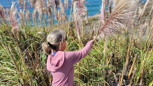 Rear view of woman standing on field