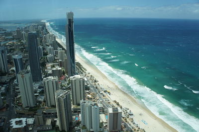 High angle view of cityscape by sea against sky