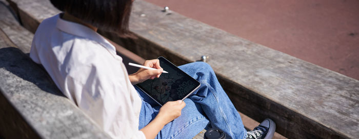 Low section of woman sitting on steps