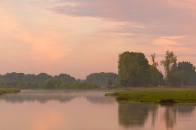 Scenic view of lake against sky during sunset