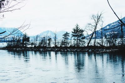 Scenic view of lake against sky during winter