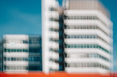 Low angle view of modern buildings against clear blue sky