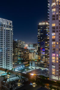 Illuminated buildings in city at night