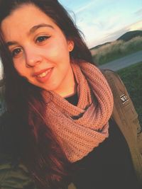 Portrait of smiling woman at beach against sky