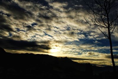 Low angle view of silhouette mountain against dramatic sky