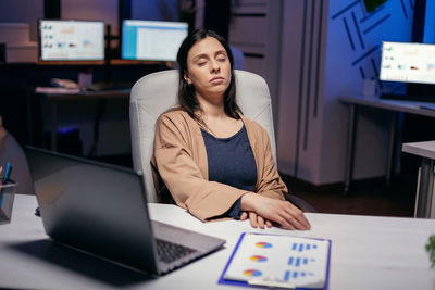 Overworked businesswoman resting at office