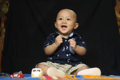 Portrait of cute baby girl sitting