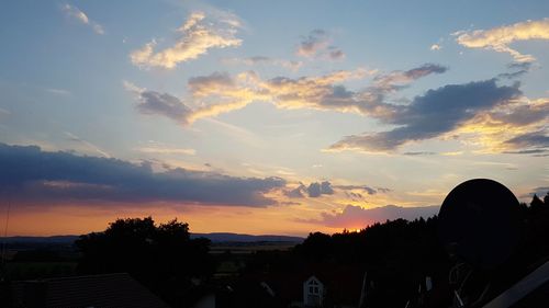 Silhouette buildings against sky during sunset