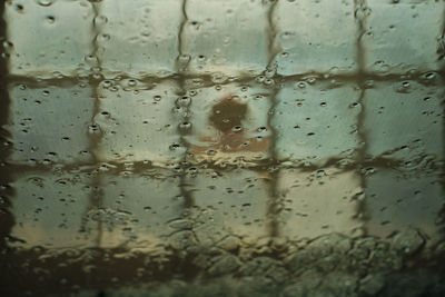 Full frame shot of wet glass window in rainy season