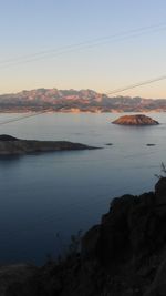 Scenic view of sea and mountains during sunset