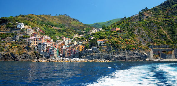 Scenic view of sea and buildings in town