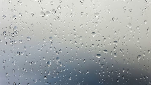 Full frame shot of wet glass window