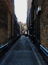 Narrow street amidst buildings in city