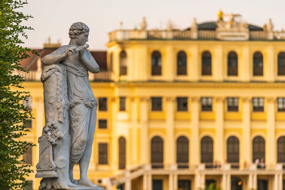 Low angle view of statue against building