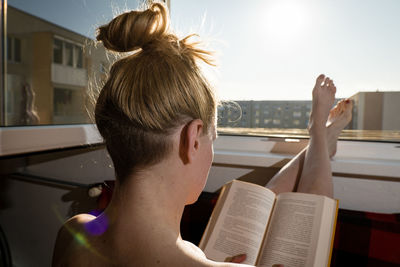 Portrait of young man sitting on book