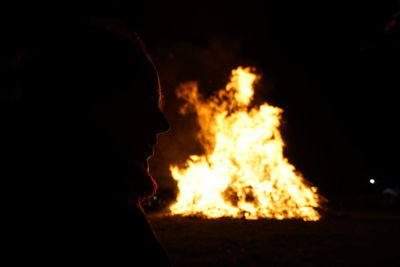 Portrait of woman against bonfire at night