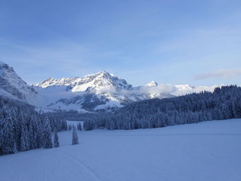 Scenic view of snowcapped mountains against sky