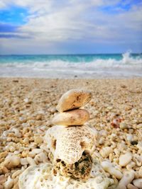 Pebbles on beach against sky