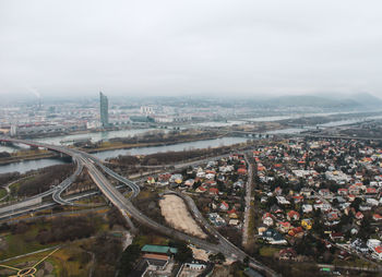 High angle view of road amidst buildings against sky