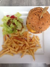 Close-up of burger and vegetables on plate