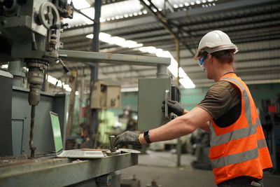 Portrait of male worker standing in the heavy industry manufacturing factory.