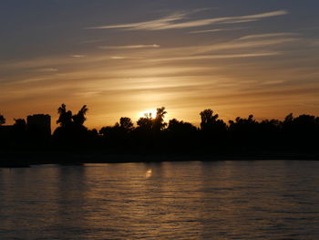Scenic view of silhouette trees against sky at sunset