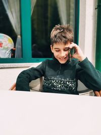 Boy sitting on mobile phone