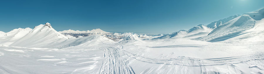 Panoramic view of snowcapped mountains against sky