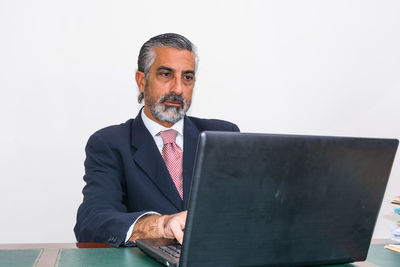 Mid adult man using laptop on table