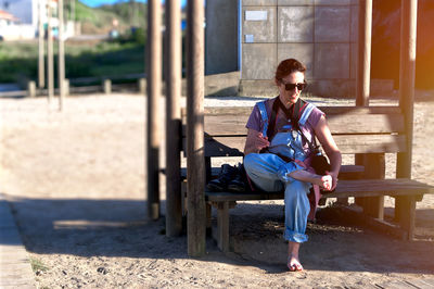 Full length of woman sitting on field