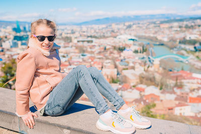 Portrait of man sitting on sunglasses