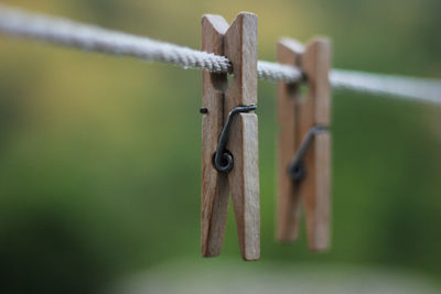 Close-up of clothes pegs on rope