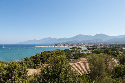 Scenic view of sea and buildings against clear sky