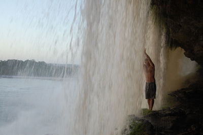 Woman standing in water at sea