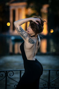 Midsection of woman standing by railing