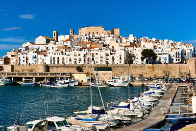 Boats moored at harbor in peniscola